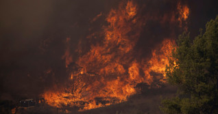 Battle to contain Southern California canyon blaze aided by easing winds