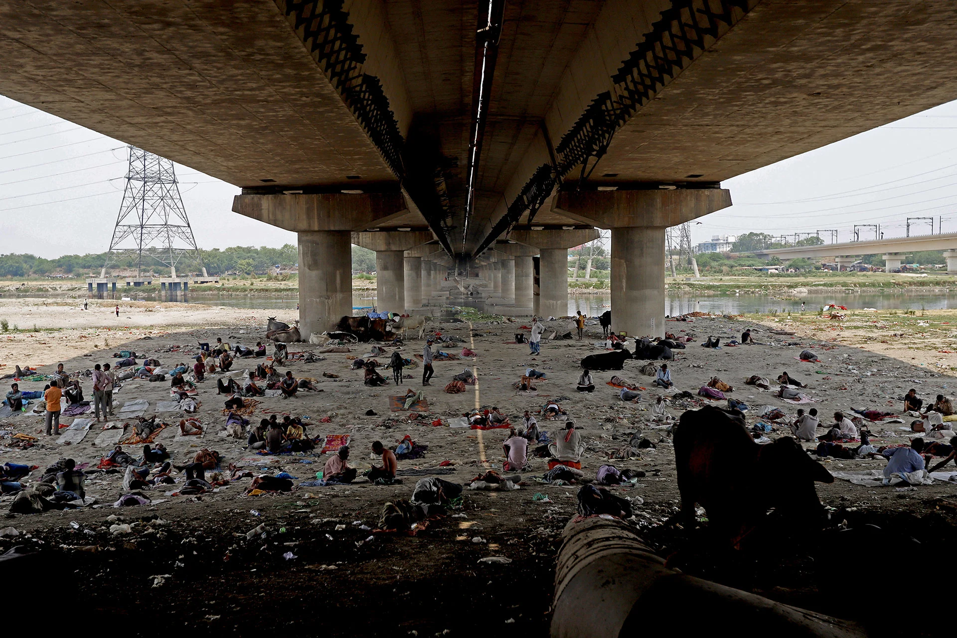 People take rest under a bridge at the Yamuna River bed on a hot summer day in New Delhi, India on May 10, 2022.  (Amarjeet Kumar Singh/ Anadolu Agency/ Getty Images)