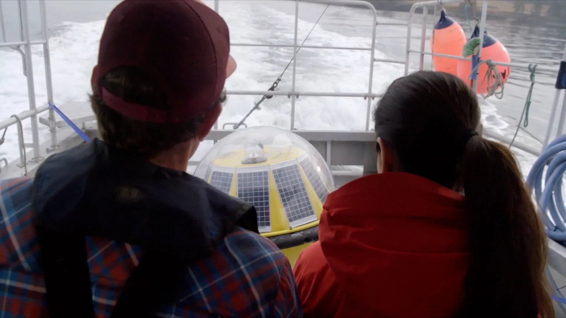 Laboucan-Massimo and Robertson out at sea deploying a research buoy. (Power to the People)