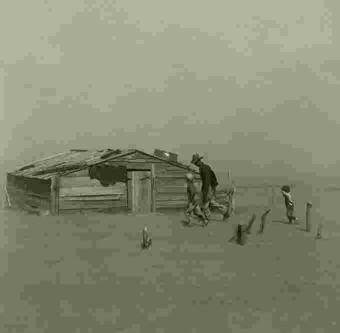 1280px-Farmer walking in dust storm Cimarron County Oklahoma2