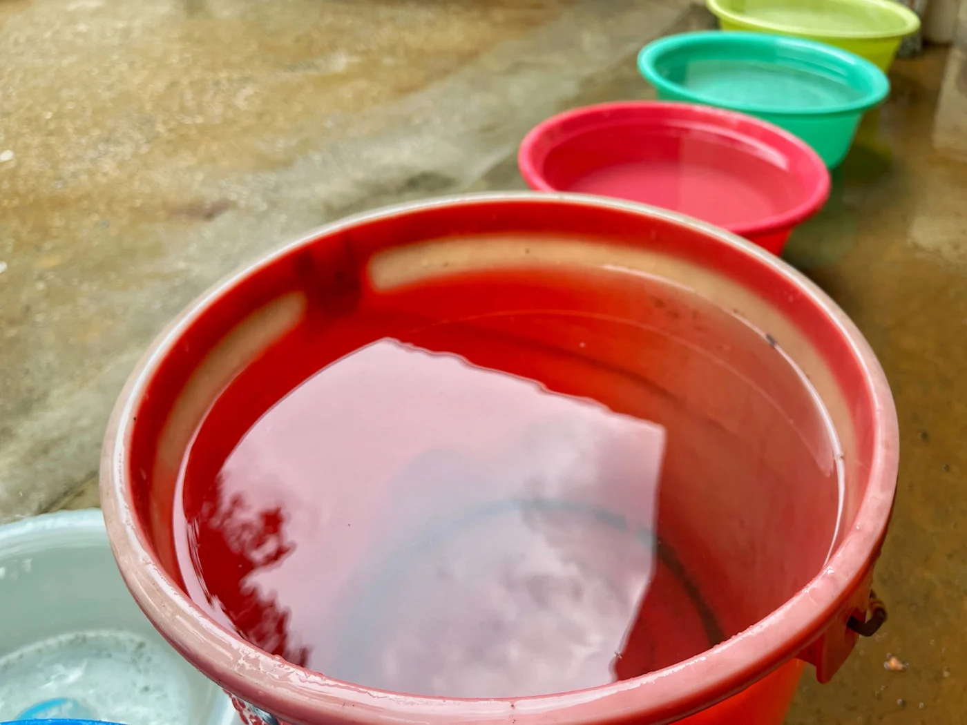 Close-up of a row of colourful pails with collected rainwater as part of recycling effort in Singapore. (Calvin Chan Wai Meng/ Moment/ Getty Images)