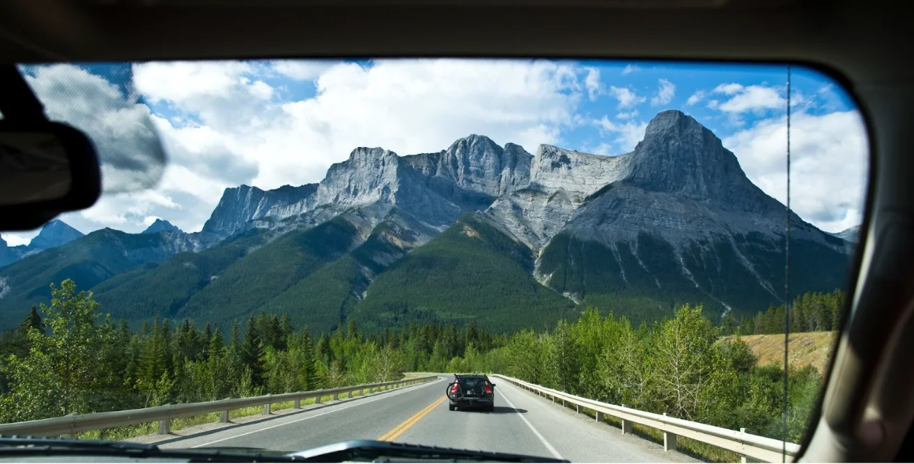 Getty Images/Stock photo: Clear windshield, mountain view, summer drive, travel.