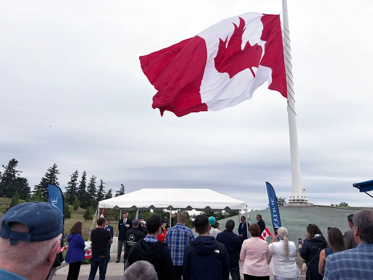 Spectators watch as Ontario-s biggest Canadian flag is raised in Barrie Ont. (Lauren O'Neil)