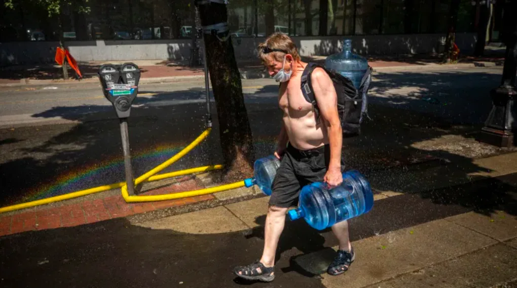 Man carrying water jugs in BC Ben Nelms/CBC