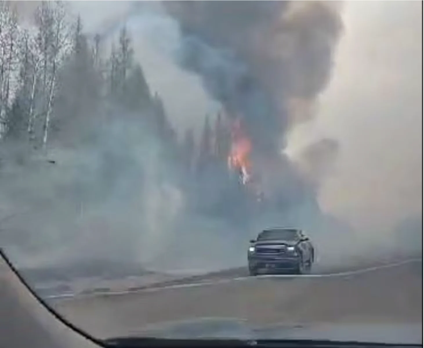 CBC: An image of the fire near Whitecourt captured by evacuee Jessica Adams as she drove to safety Monday evening. (Jessica Adams)