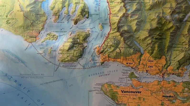 CBC Clark shows population densities on his map by using the colour orange in contrast to the green and blue nature landscapes. (Alanna Kelly/CBC)