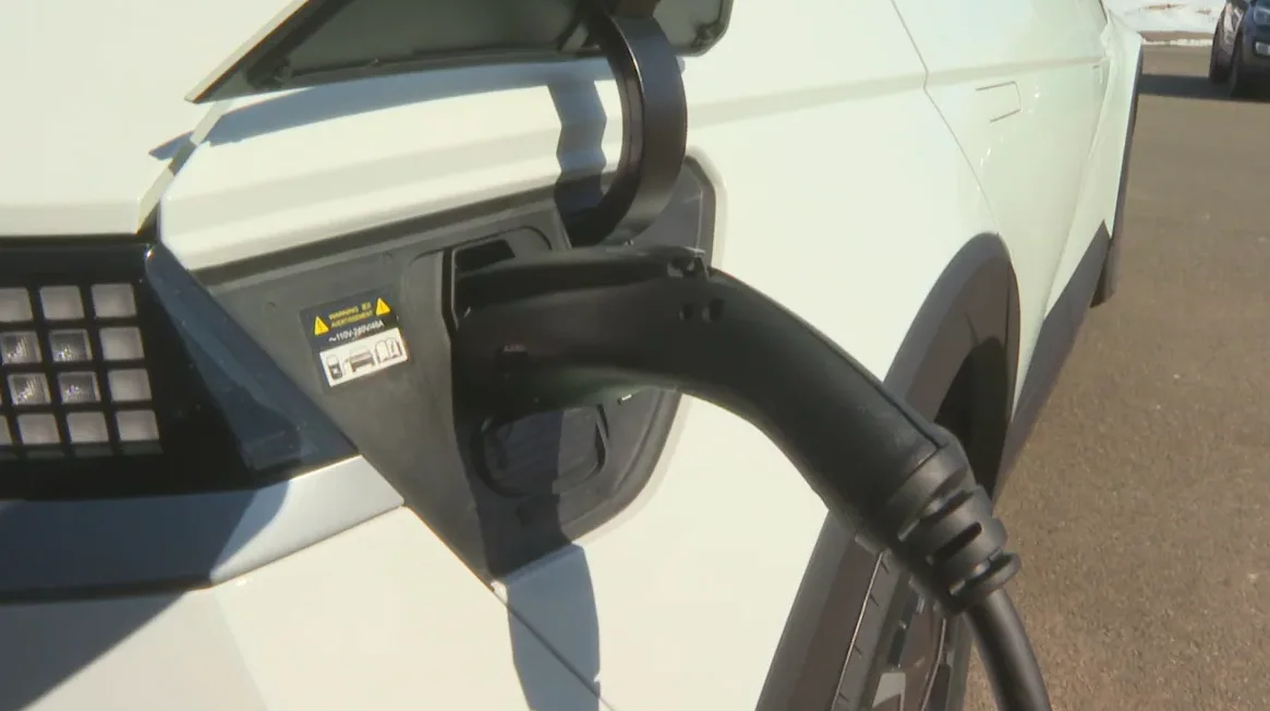 An electric vehicle fills up at a charging station. (Brittany Spencer/CBC)