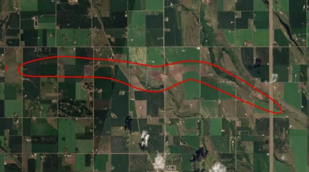 CBC: A satellite image shows a brown streak where a tornado cut through farmland in a rural area north of Calgary. (Northern Tornadoes Project )