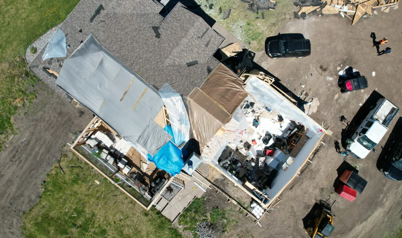 Drone image showing partial roof removal from a home near Atmore, AB - NTP