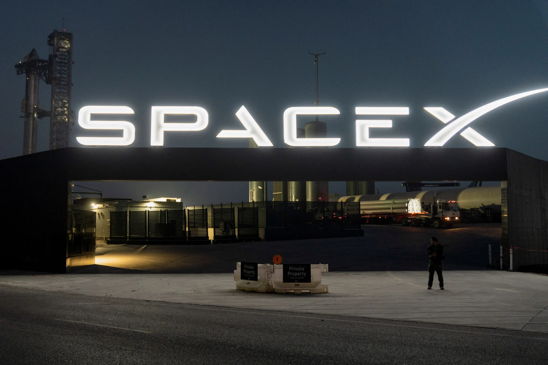 REUTERS: A security guard monitors the entrance as SpaceX's next-generation Starship spacecraft atop its powerful Super Heavy rocket is prepared for a third launch from the company's Boca Chica launchpad on an uncrewed test flight, near Brownsville, Texas, U.S. March 13, 2024. REUTERS/Cheney Orr