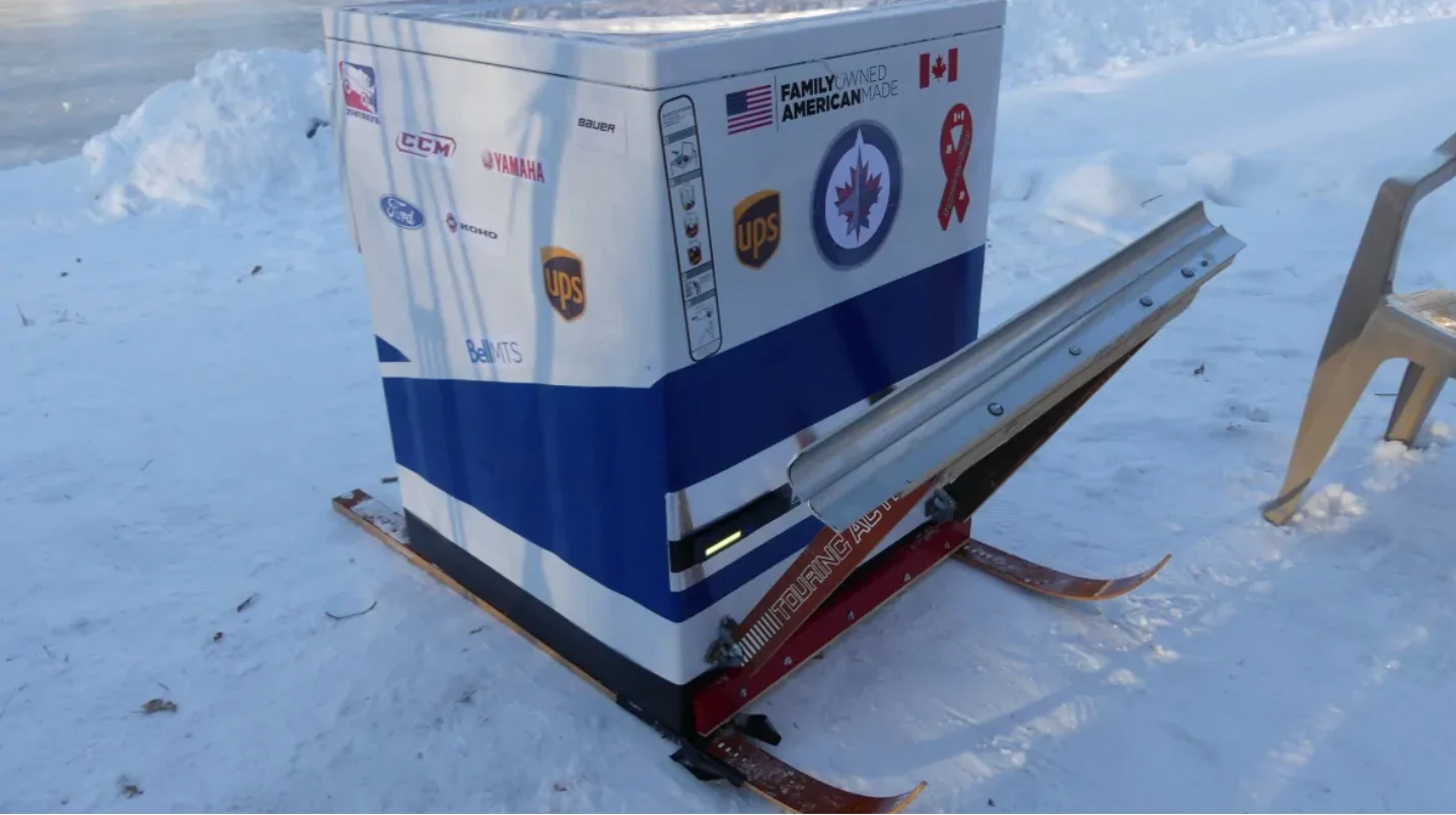 CBC: The ice resurfacer, which carries between 30 to 40 gallons of water, sports a Zamboni logo sticker, the Winnipeg Jets logo and various advertisements. The machine has a shovel blade attachment on the front to help clear snow off the ice surface, should the need arise. Skis were installed on the bottom for easier transportation. (Walther Bernal/CBC)