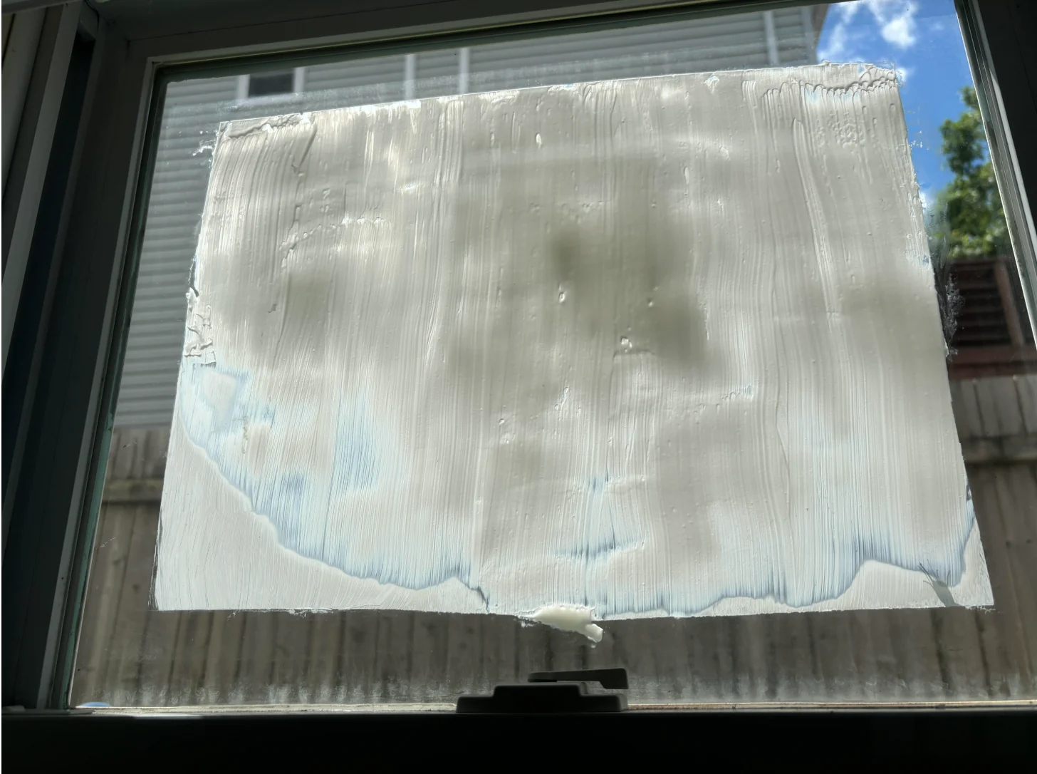 Nathan Coleman adds yogurt on window to cool home