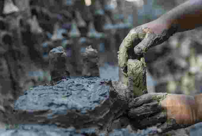 Land Art artist Francois Monthoux is working on his "Monthoux Castle" Made from clay extracted from the dried bed of the Le Toleure river in Saubraz, Switzerland, due to the ongoing drought on August 12, 2022.  REUTERS/Denis Balibouse