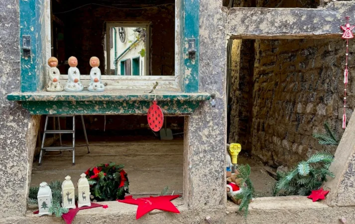 Christmas decorations are seen in the broken window panes of some gutted buildings in Dernau. (Natalie Carney/CBC)