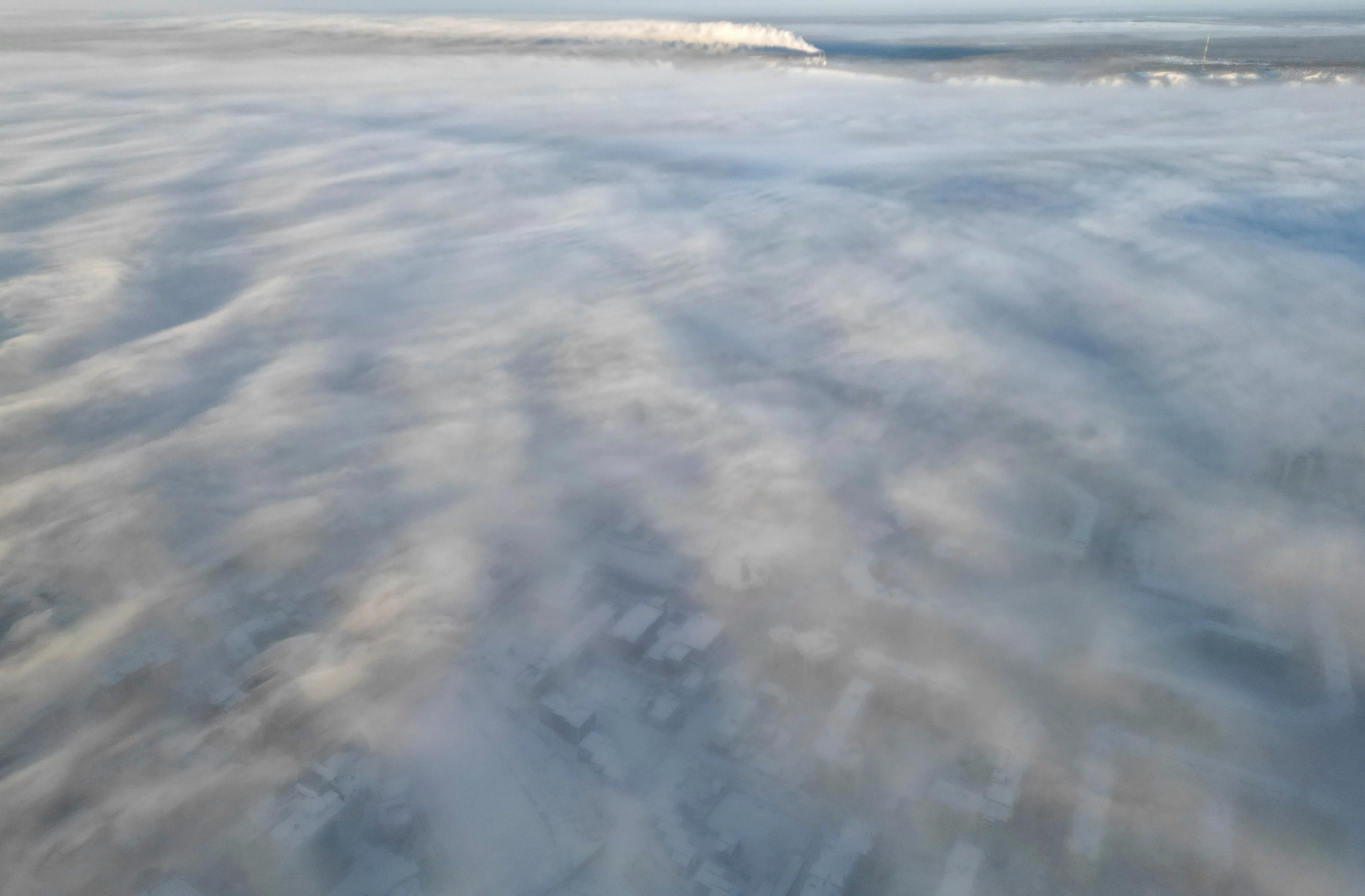 Reuters: An aerial view through clouds and fog shows the city of Yakutsk, Russia, December 5, 2023. Temperatures in parts of the Sakha Republic, also known as Yakutia and located in the northeastern part of Siberia, went below minus 50 degrees Celsius (minus 58 degrees Fahrenheit) on December 5. REUTERS/Roman Kutukov