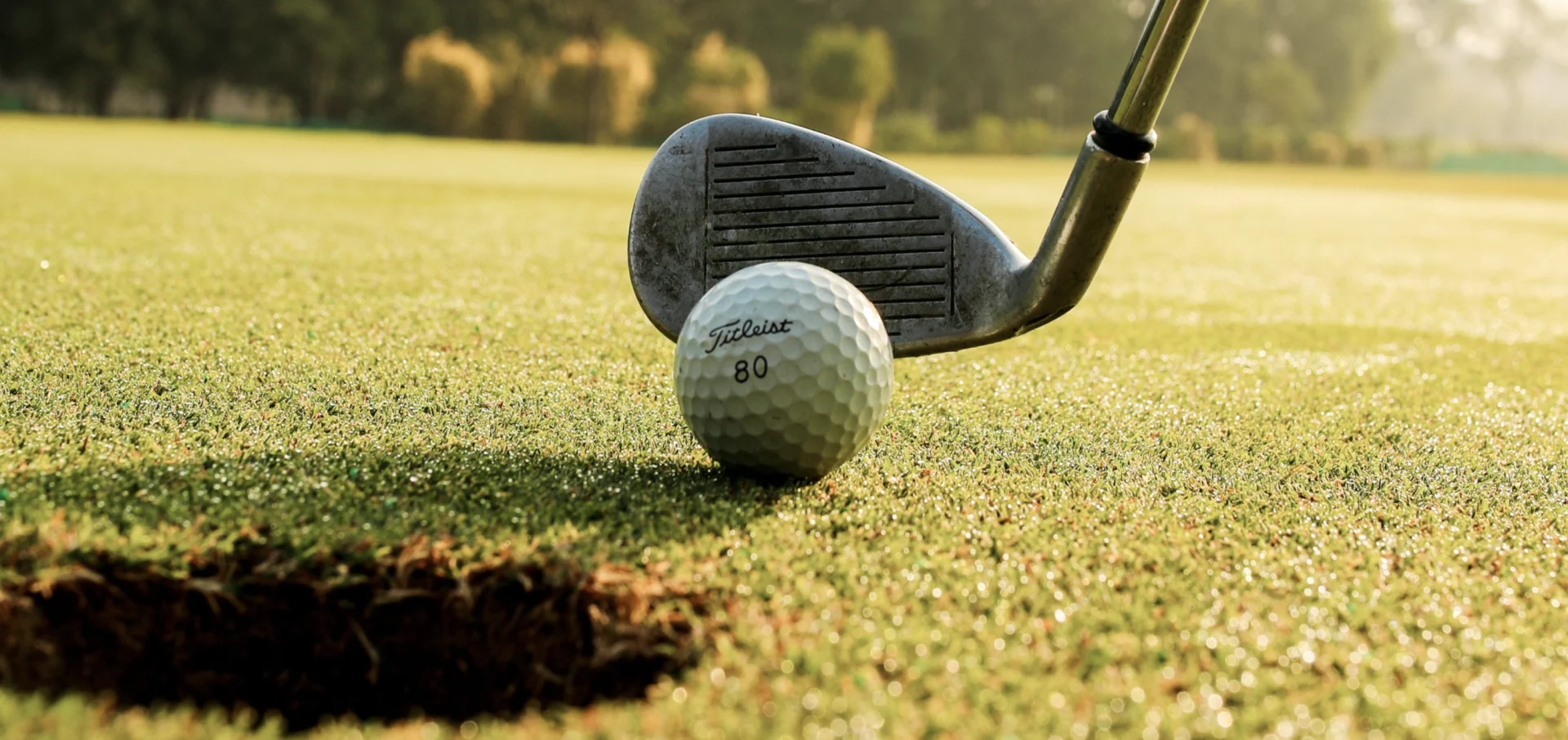 Pexels/Nadim Shaikh: Golf. Link: https://www.pexels.com/photo/golf-club-hitting-ball-on-field-7758348/