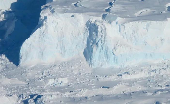 Thwaites Ice Shelf edge as seen from the IceBridge DC-8 on Oct. 16, 2012. The blue areas of ice are denser, compressed ice. Credit: NASA / James Yungel