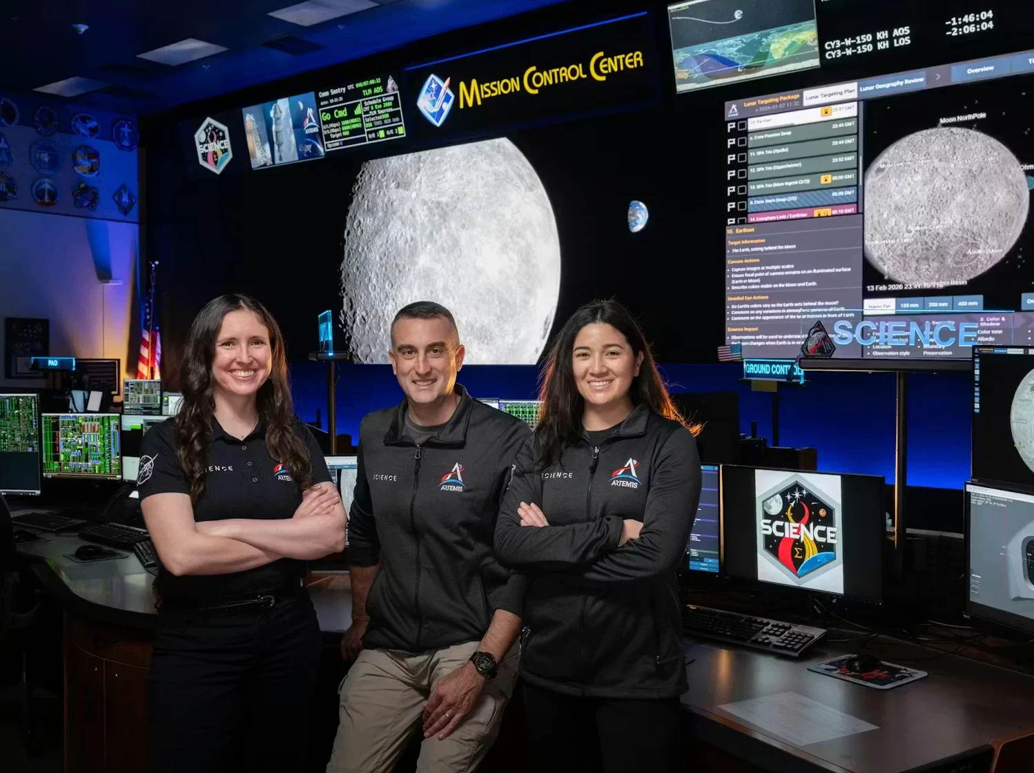 NASA: Artemis science officers, from left, Kelsey Young, Trevor Graff, and Angela Garcia stand at the new SCIENCE console in the Mission Control Center at NASA’s Johnson Space Center in Houston. (NASA/Josh Valcarcel)