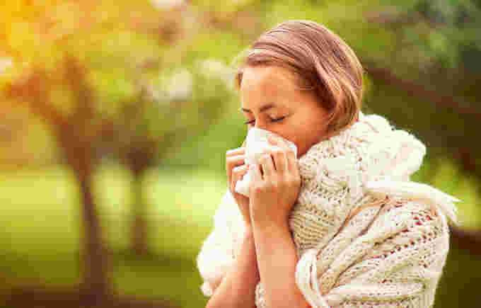 Getty Allergies Woman Sneezing