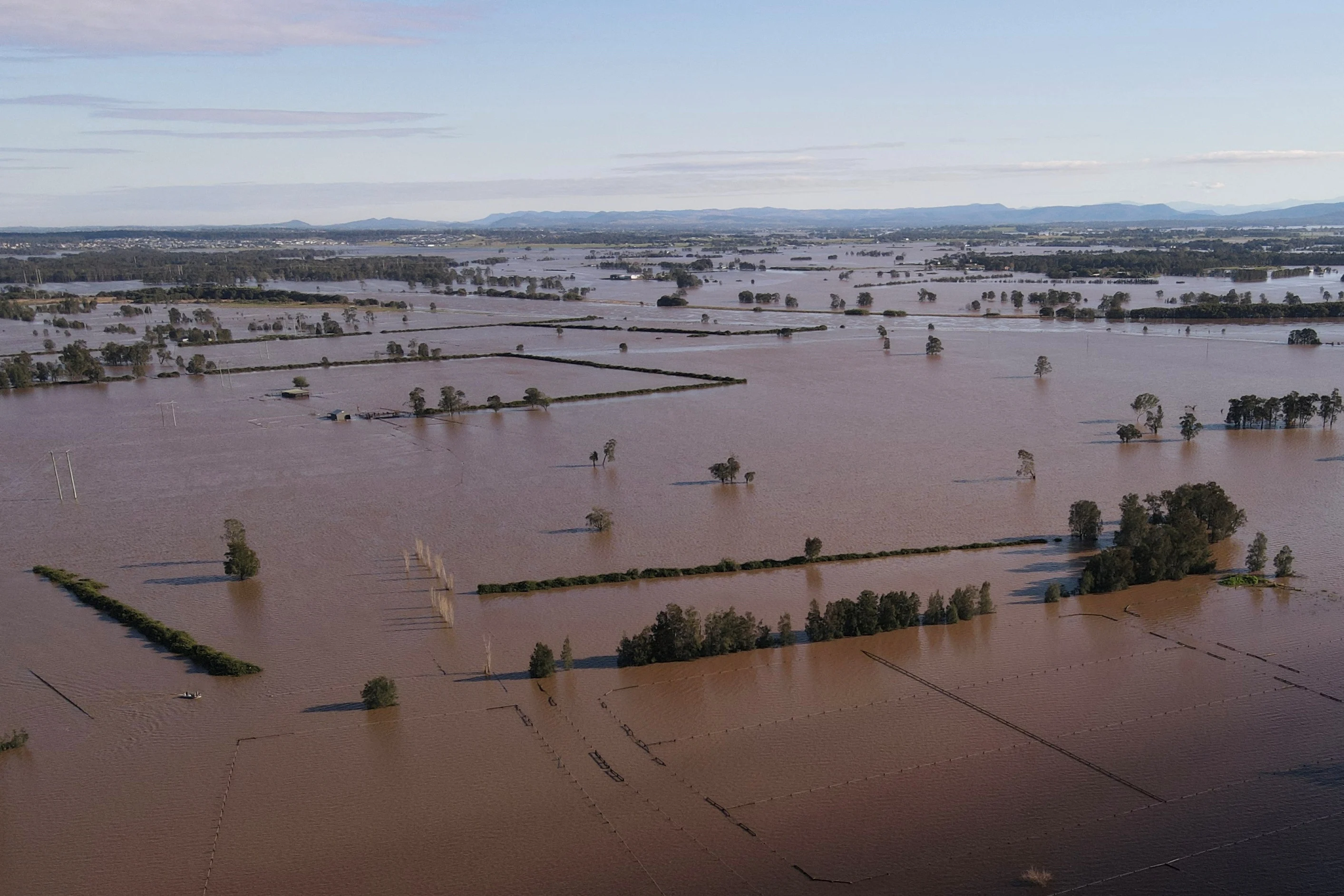 Reuters A drone view shows a flooded area near the Hunter River in Heatherbrae, Australia, May 24, 2025. REUTERS/Hollie Adams
