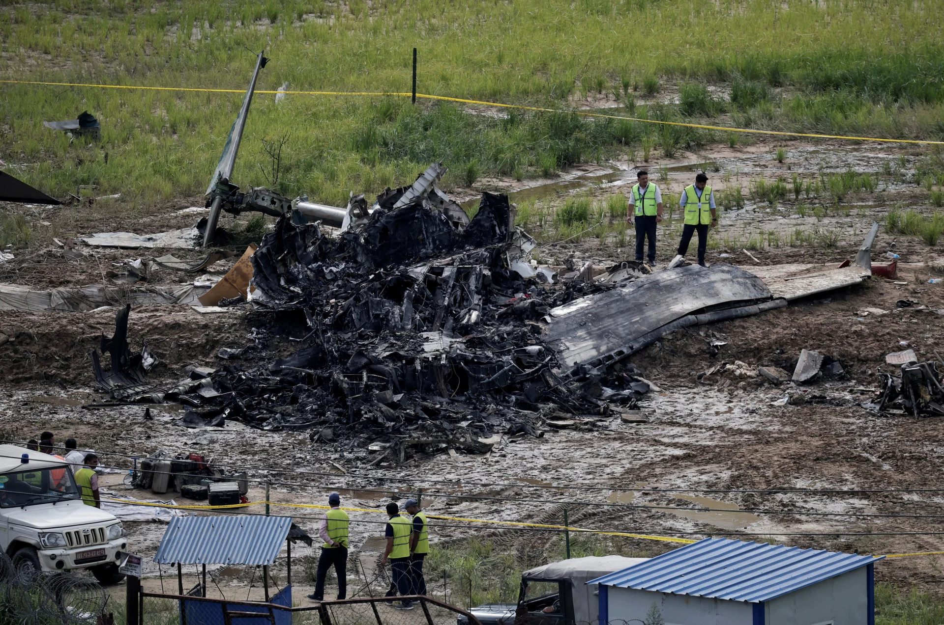 Reuters: Officials from the airport stand near the wreckage of a Saurya Airlines plane that caught fire after skidding off the runway while taking off at Tribhuvan International Airport, in Kathmandu, Nepal, July 24, 2024. REUTERS/Navesh Chitrakar