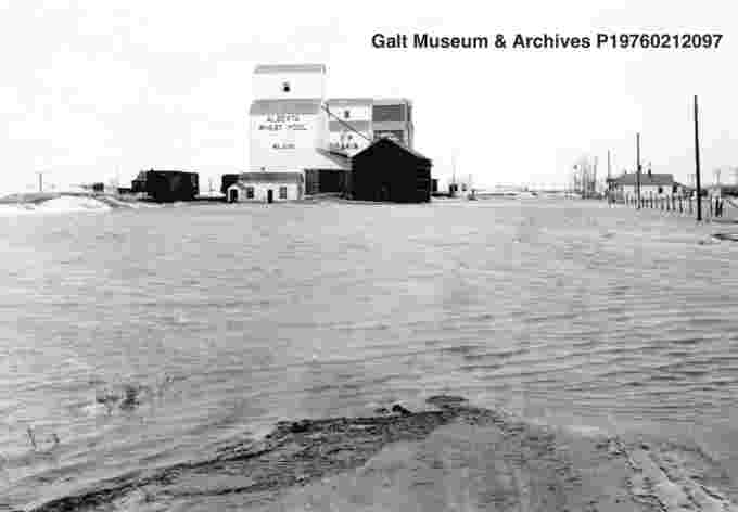 Screen Shot 2021-04-08 at 10.02.19 PMA road and field at Wilson is flooded by melting snow from the April/May snowstorms. Elevators and houses are visible. 1967. Courtesy Lethbridge Historical Society (Facebook)