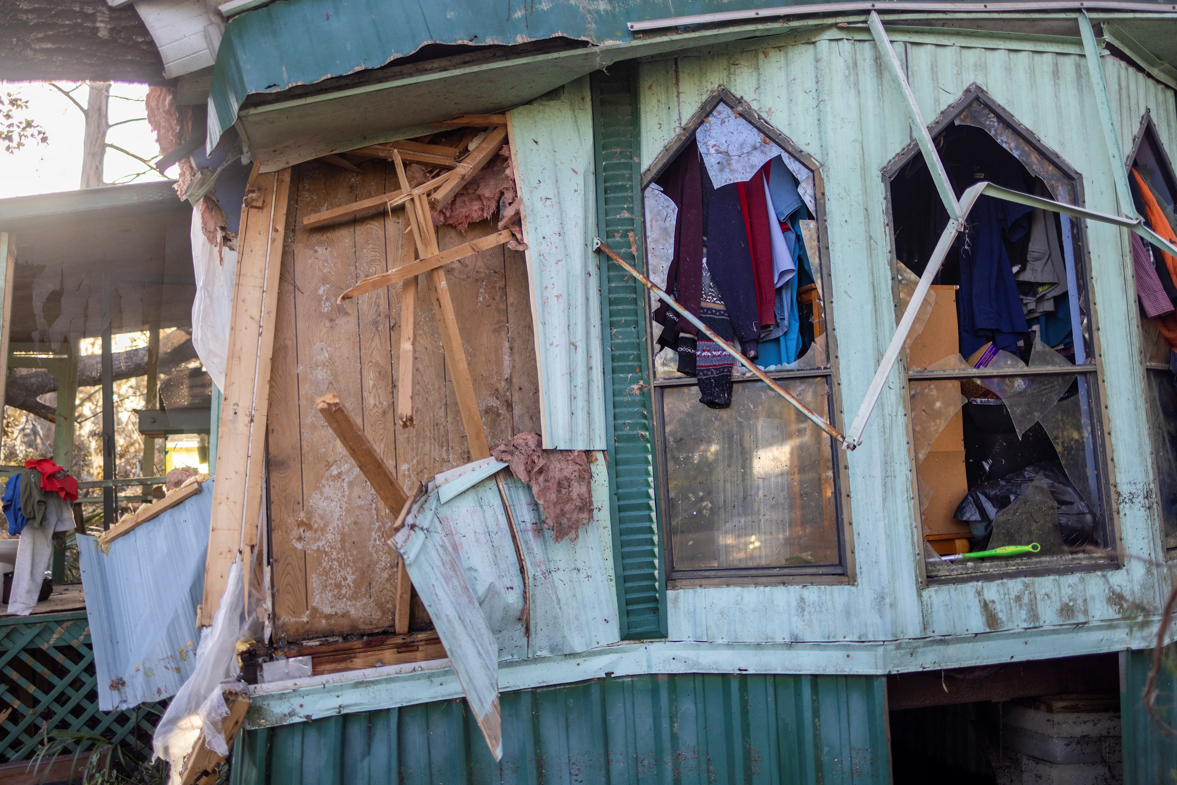REUTERS: Clothing hangs out of broken windows of a home after Hurricane Helene made landfall in Steinhatchee, Florida, U.S., September 27, 2024. REUTERS/Kathleen Flynn