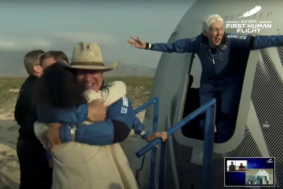 Billionaire businessman Jeff Bezos and pioneering female aviator Wally Funk emerge from their capsule after their flight aboard Blue Origin's New Shepard rocket on the world's first unpiloted suborbital flight near Van Horn, Texas, U.S., July 20, 2021 in a still image from video. Blue Origin/Handout via REUTERS.