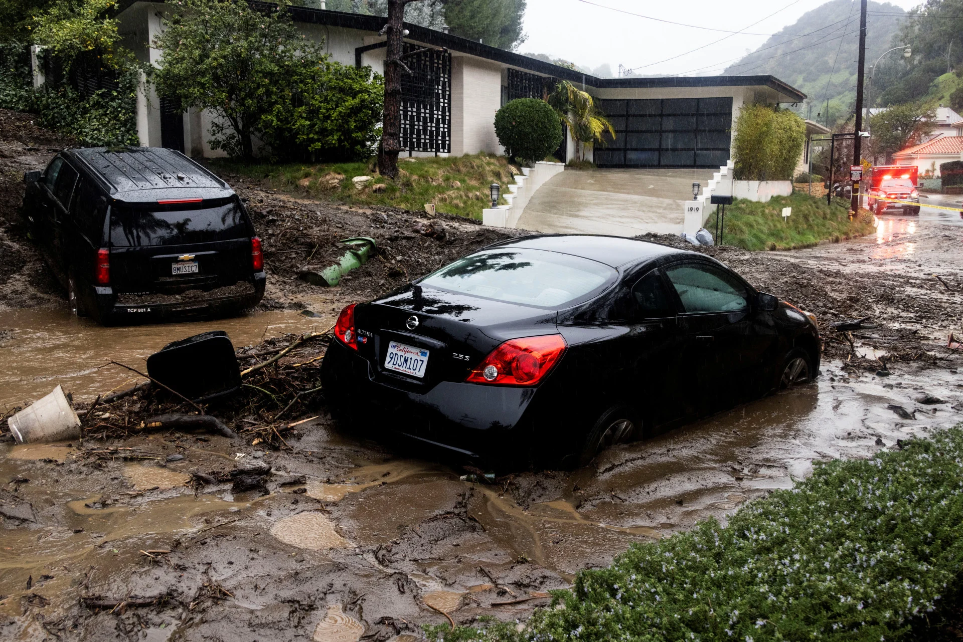 REUTERS: Rain falls over cars stuck by a mudslide, caused by an ongoing rain storm in Studio City, California, U.S., February 5, 2024. REUTERS/Aude Guerrucci