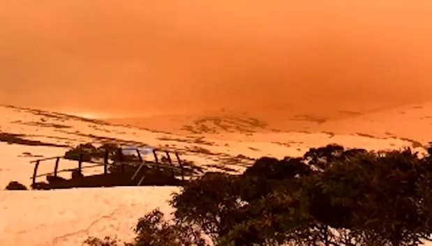 Eerie dust storm turns sky orange over snowy mountains in Australia