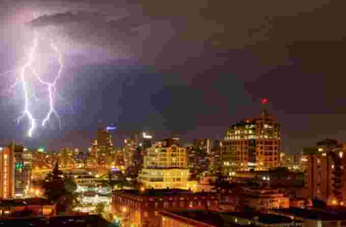 Getty Images: Lightning strike during thunderstorm over city at night