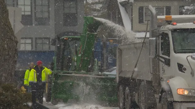 city-crews-blowing-snow-into-dump-truck-toronto