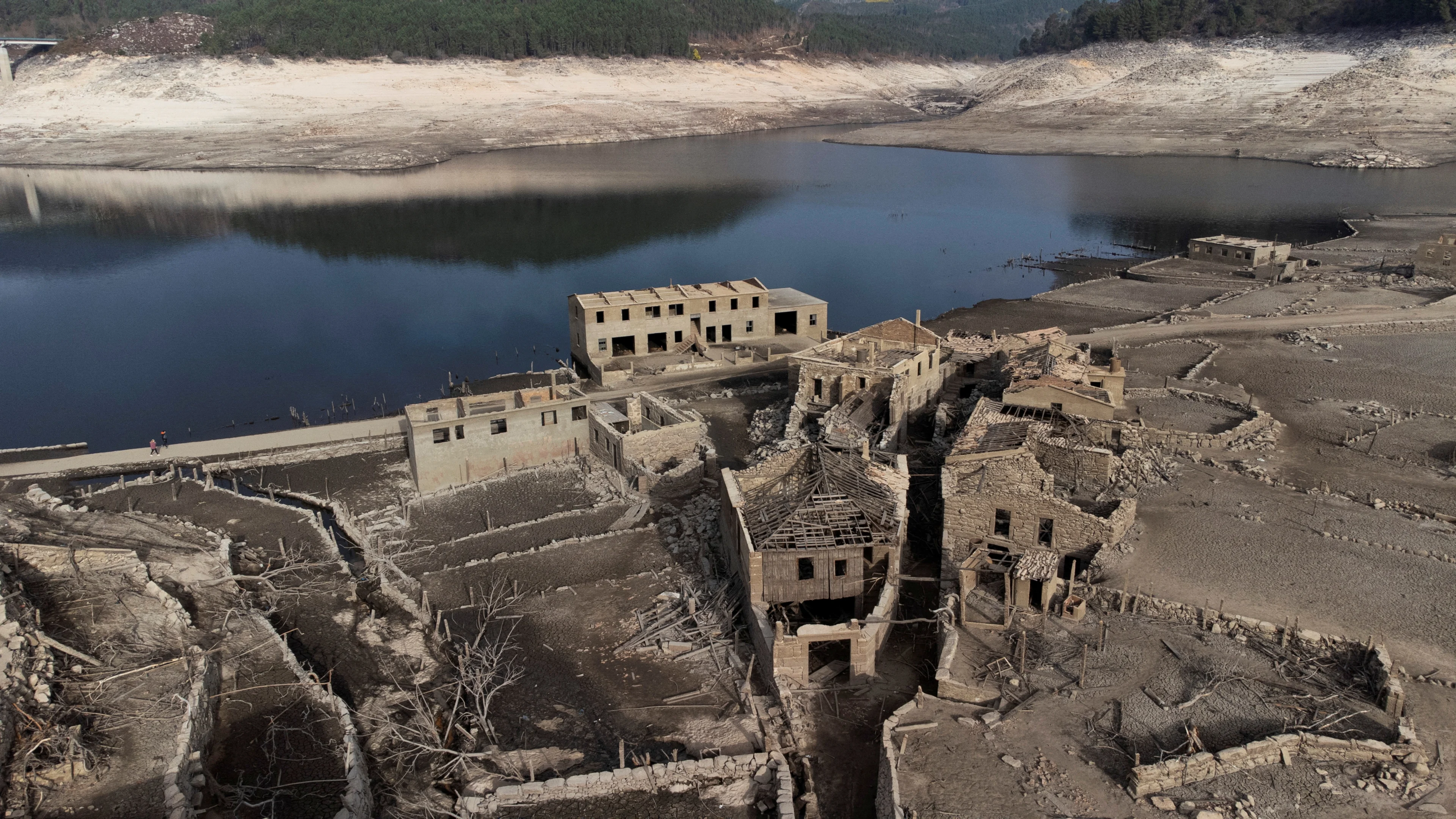 REUTERS: A general view shows the ancient village of Aceredo that had been submerged by Limia river in the 1990s after the dam was built in Concello de Lobios, Spain, February 10, 2022. Picture taken with a drone. REUTERS/Miguel Vidal