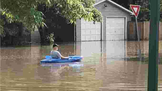 CBC: A resident in Avalon takes his kayak through flooded streets on Monday afternoon. (Steve Pasqualotto/CBC)