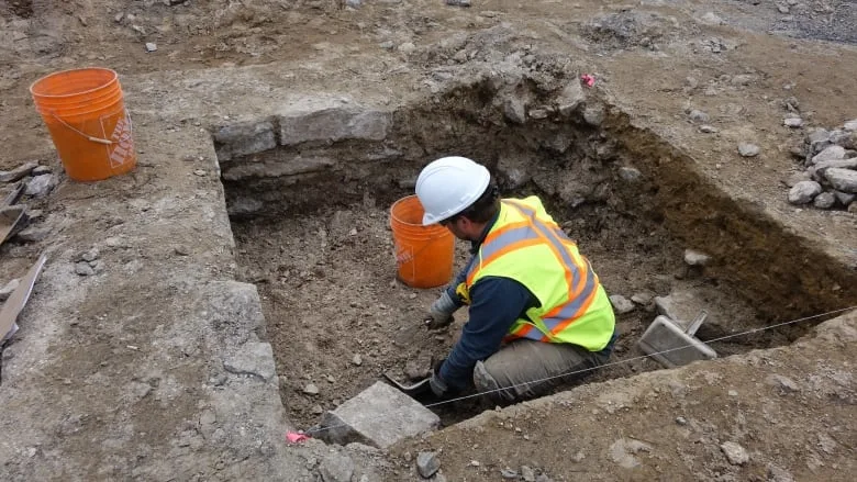 worker-digging-excavation-site-east-of-centre-block