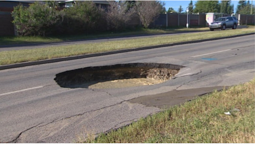 The Weather Network - Giant sinkhole partially closes busy Calgary roadway