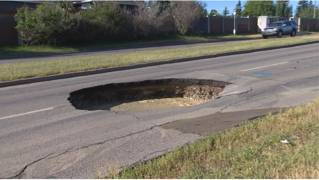 Giant sinkhole partially closes busy Calgary roadway - The Weather