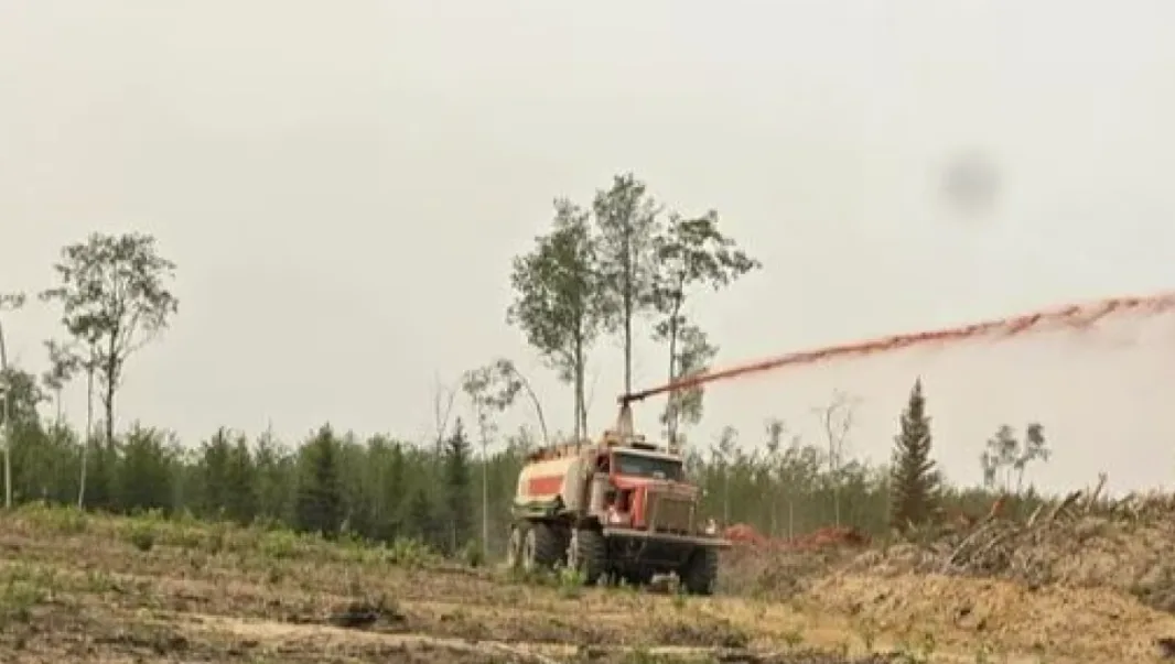 CBC: A truck sprays fire retardant in a forested area near Garden River, Alta., one of the communities threatened by the Semo Wildfire Complex. (Alberta Wildfire)