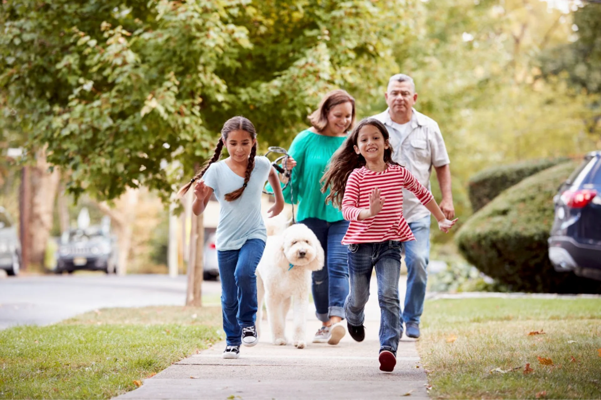 Getty Images: Family enjoying spring day with dog.