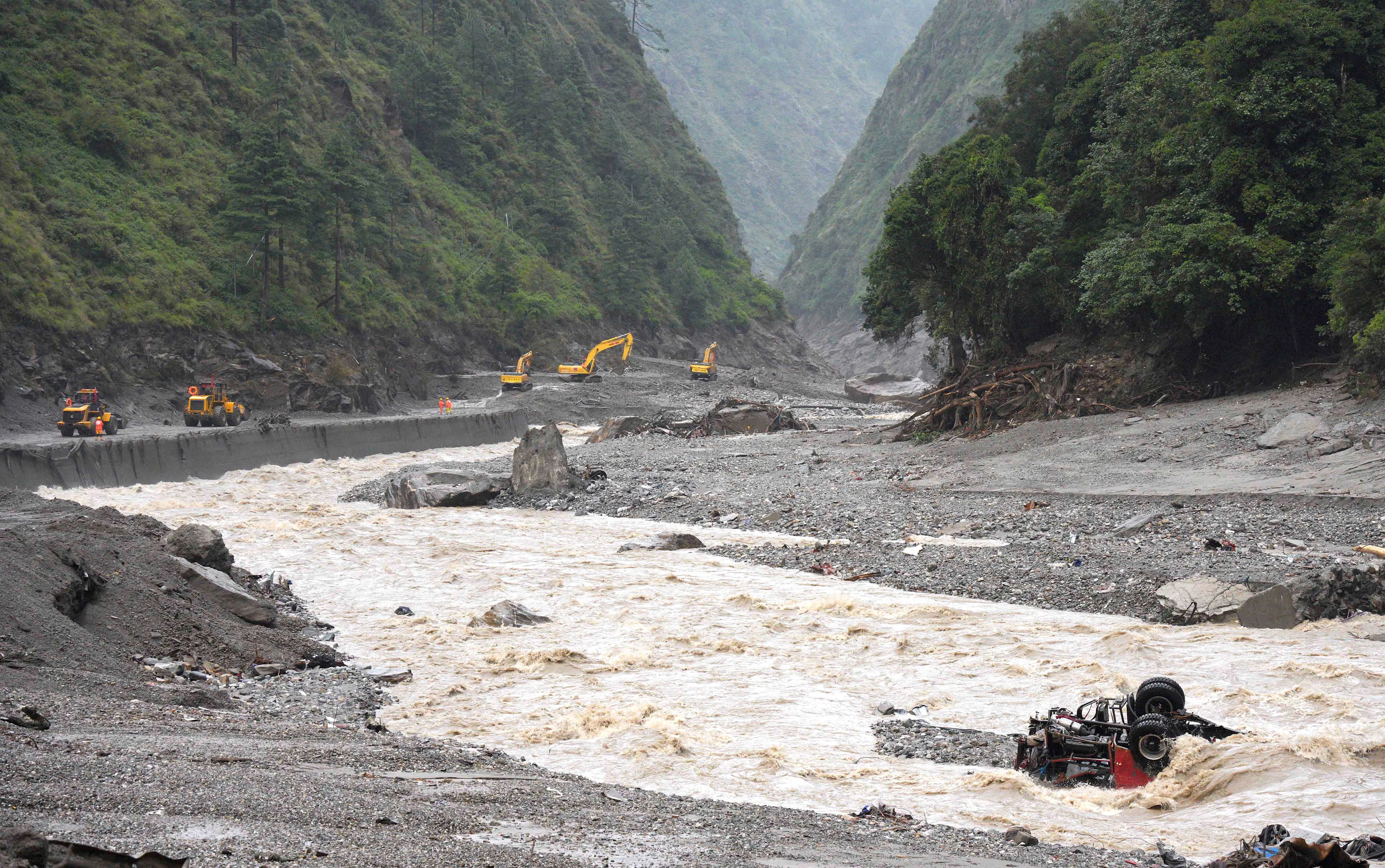 REUTERS: Excavators and loaders in action as rescue workers repair a road leading to Gyirong Port after a mudslide, in Gyirong county, Shigatse, Tibet Autonomous Region, China August 28, 2026. cnsphoto via REUTERS