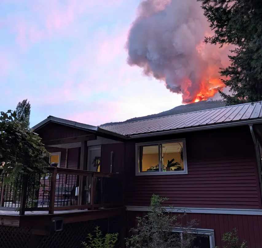 CBC - Wildfire pictured behind a home of Boston Bar BC - Attila Banhegyi - July 16