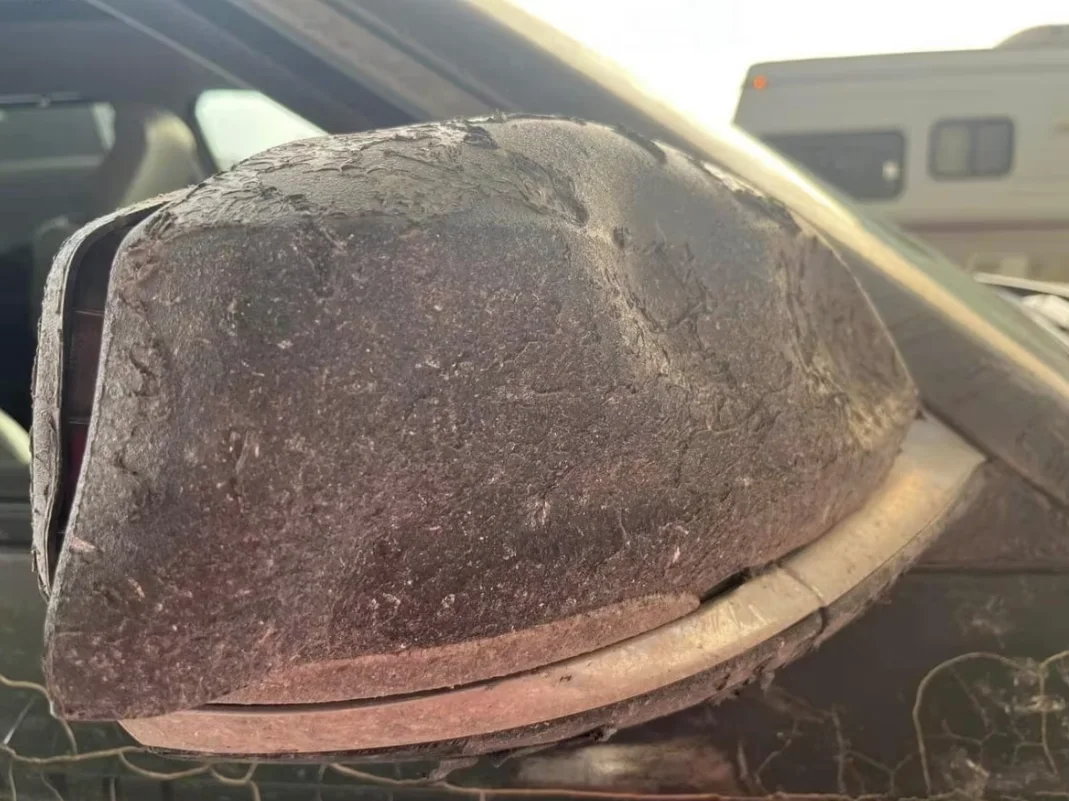 CBC: The heat-damaged mirror of Hay River resident Lisa Mundy's car. Mundy drove out of Hay River, N.W.T., Sunday at around 6:30 p.m. Her car was damaged between Paradise Gardens and Enterprise, N.W.T. Mundy is now safe in Valleyview, Alberta. (Submitted by Lisa Mundy)