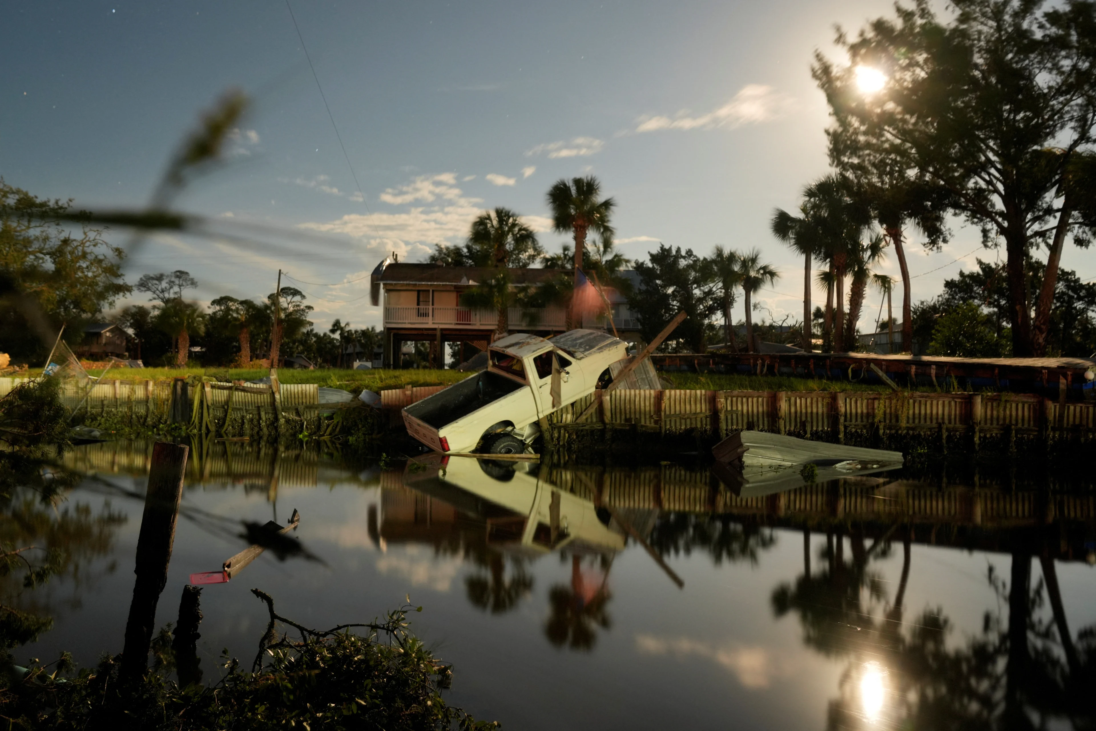 Reuters: A vehicle is seen in a canal after the arrival of Hurricane Idalia in Horseshoe Beach, Florida, U.S., August 30, 2023. REUTERS/Cheney Orr
