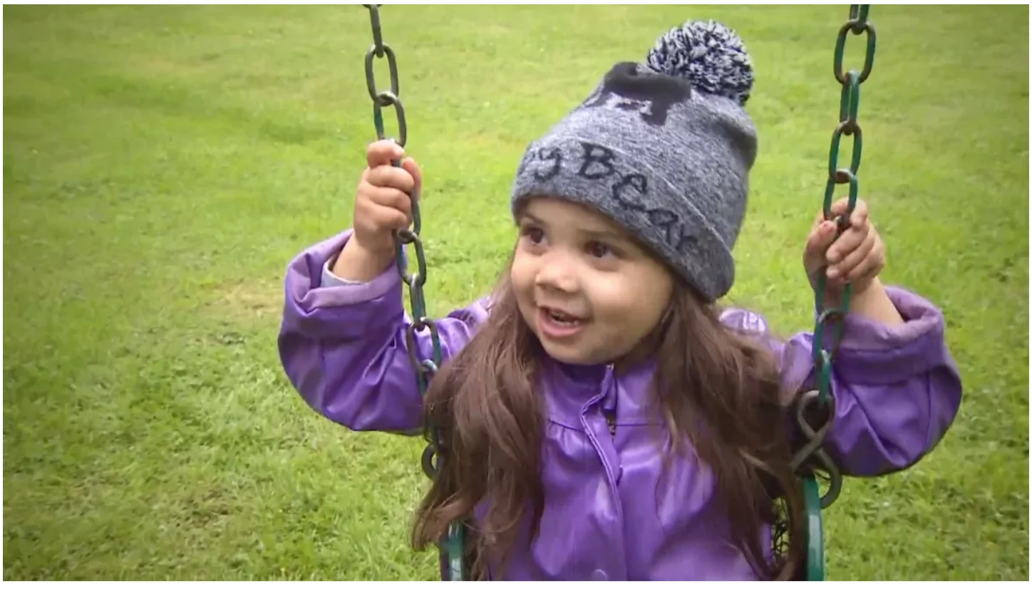 After a few days in the hospital struggling against paralysis caused by a tick, Malia Radmore is back to health and happy to swing in her yard. (Jim Mulleder/CBC)