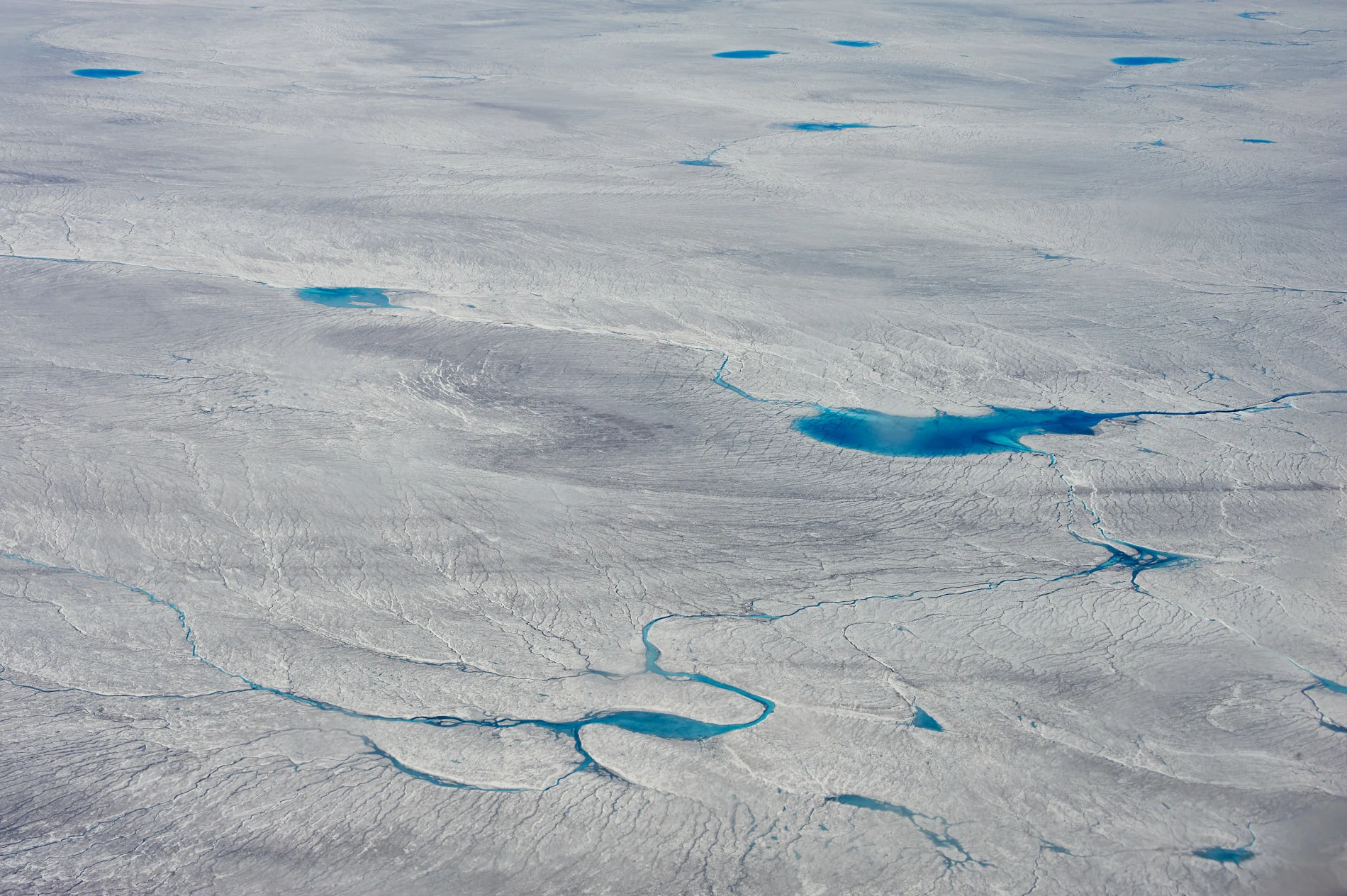 Melt ponds at the Greenland’s Ice sheet margin, flight to Kangerlussuaq, end of June 2012. (Sepp Kipfstuhl)