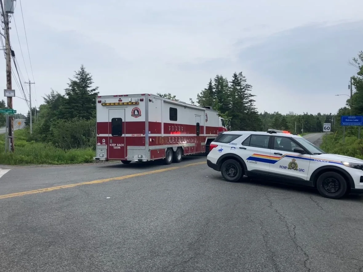 CBC Emergency vehicles block the turn from the No. 7 highway to the Ostrea Lake Road. (Josh Hoffman/CBC)