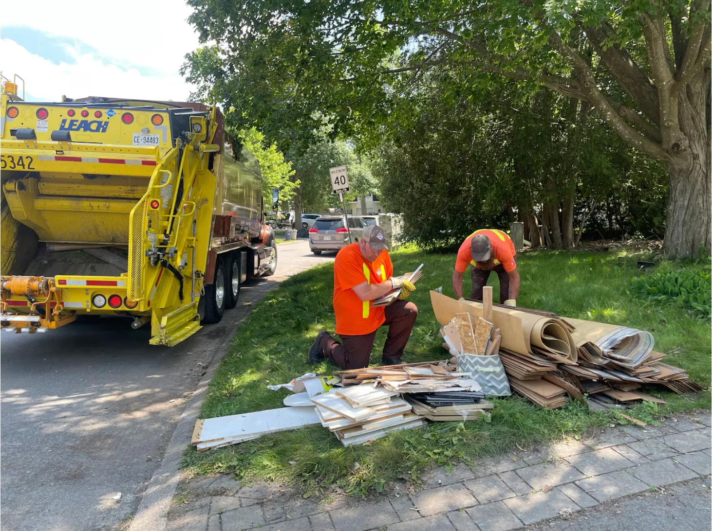 CBC: Employees with Miller Waste Systems, a company hired by the City of Ottawa to handle waste and recycling pickup, collect discarded materials left out by people whose homes were flooded in last week's storm. (Cassandra Bellefeuille/CBC)