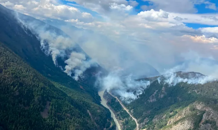 CBC: The Ainslie Creek fire burns along the Fraser River on July 27, 2026. (B.C. Wildfire Service)