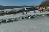 Cracking ice sheet swallows dozens of vehicles in Russia