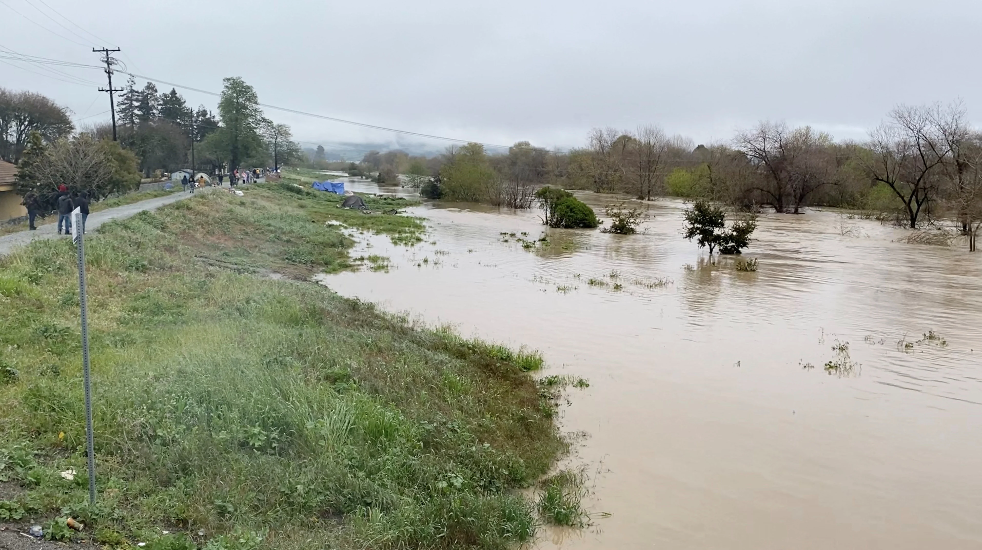 Reuters: A view shows the overflowing Pajaro River in Pajaro, California, U.S. March 11, 2023 in this screen grab obtained from a social media video. Twitter @BobbieGrennier/via REUTERS